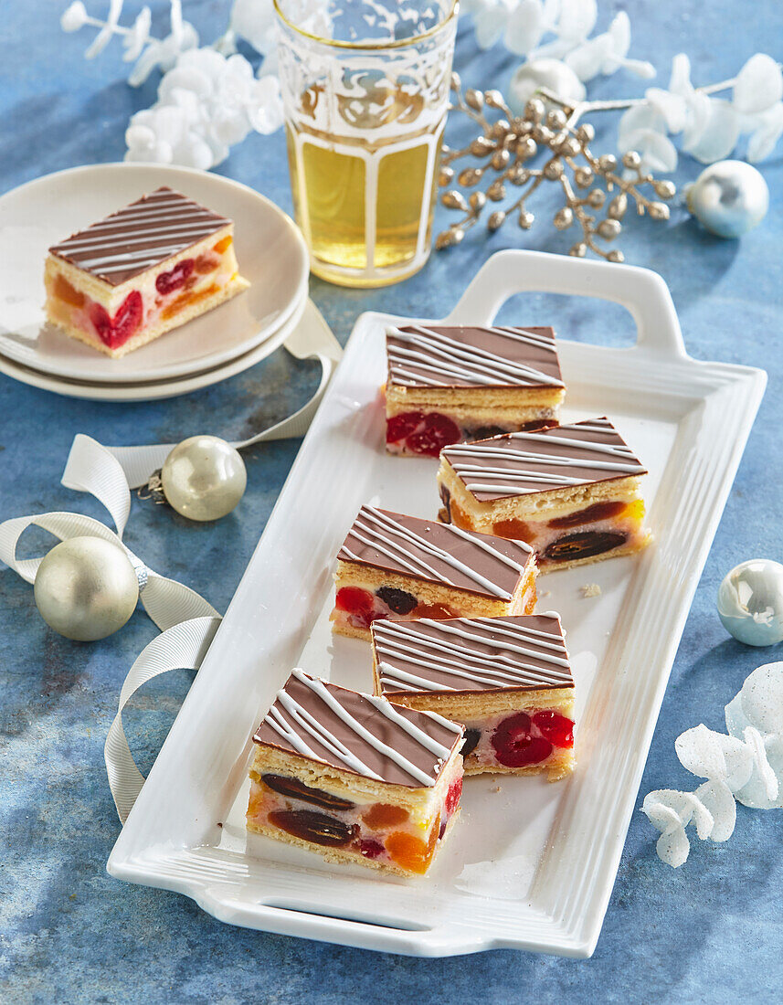 Schichtkuchen mit Trockenfrüchten und Nüssen, Glasur und Schokoladenstreifen