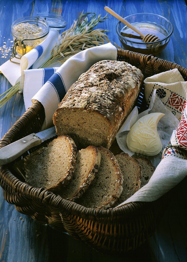 Finnenbrot (oat bread), piece cut, in basket & piece of butter
