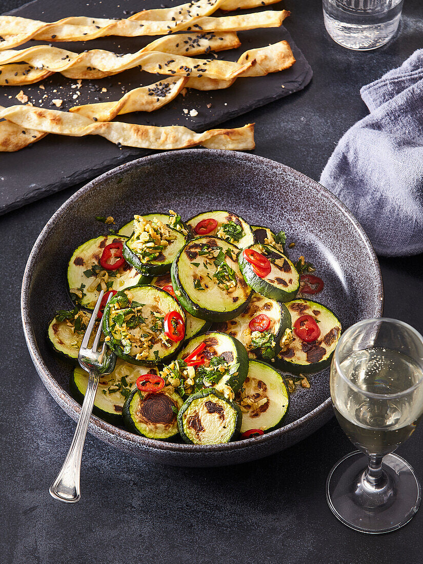 Fried courgette slices with garlic, chilli and herbs