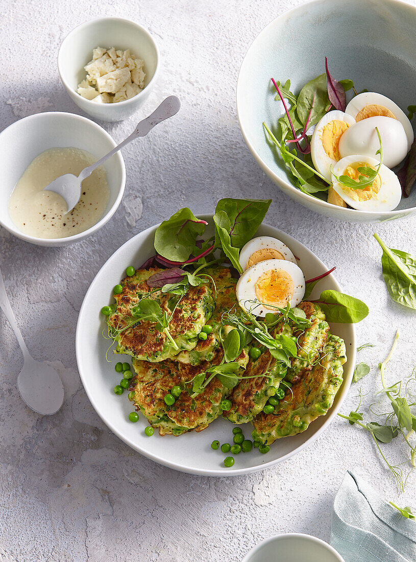 Courgette pancakes with peas, boiled egg and microgreens