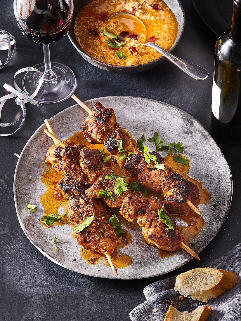 Savoury pork skewers with herbs and dip