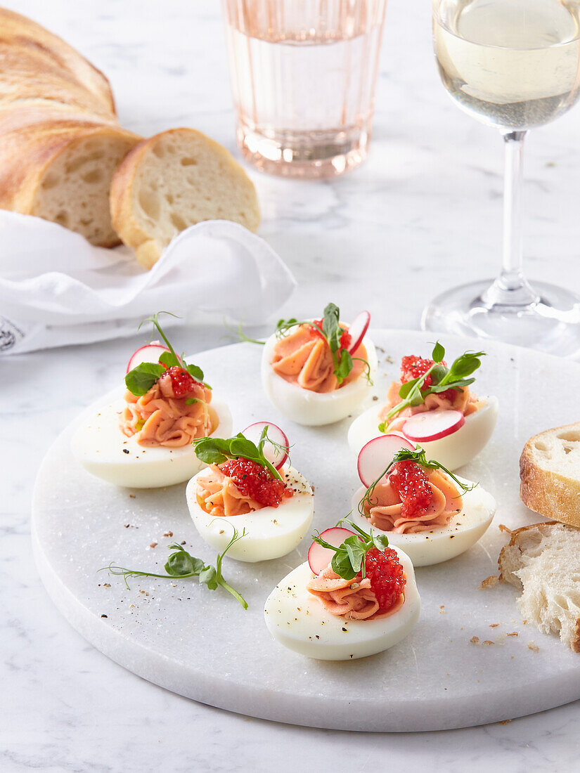 Stuffed eggs with radishes, microgreens and caviar