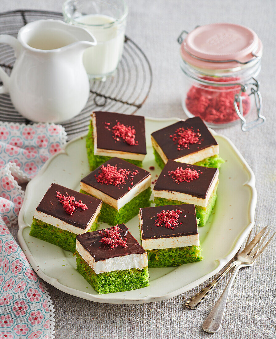 Sweet spinach cake with cream cheese filling, chocolate icing and raspberry decoration