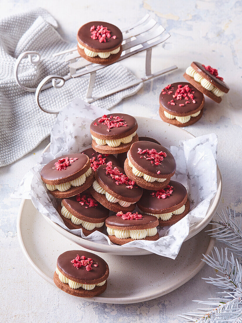 Biscuits with white chocolate cream and raspberry pieces