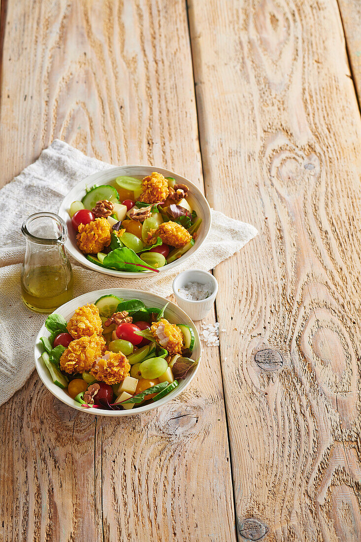 Mixed salad with chicken nuggets and nuts