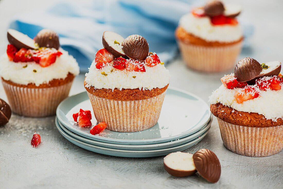 Cupcakes with coconut, strawberries and chocolate eggs