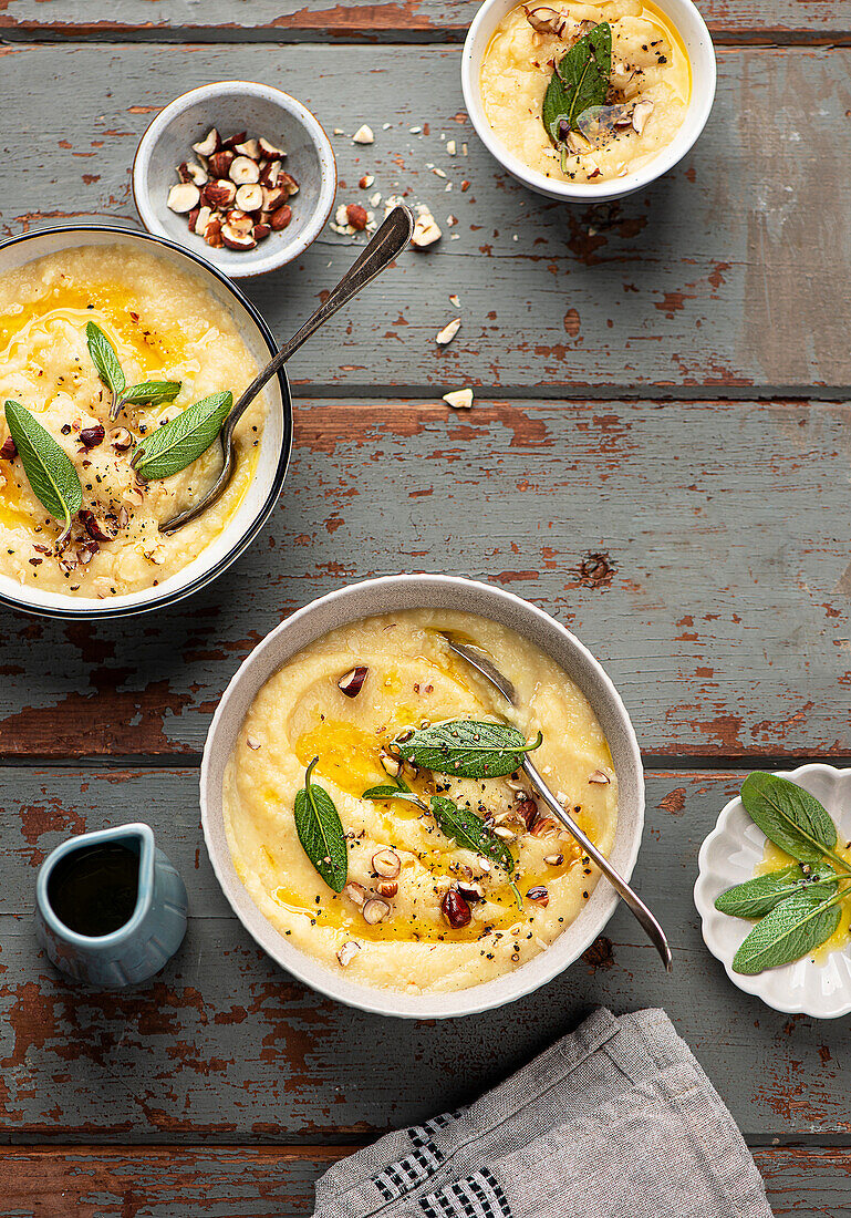 Celery and apple soup with hazelnuts and sage leaves