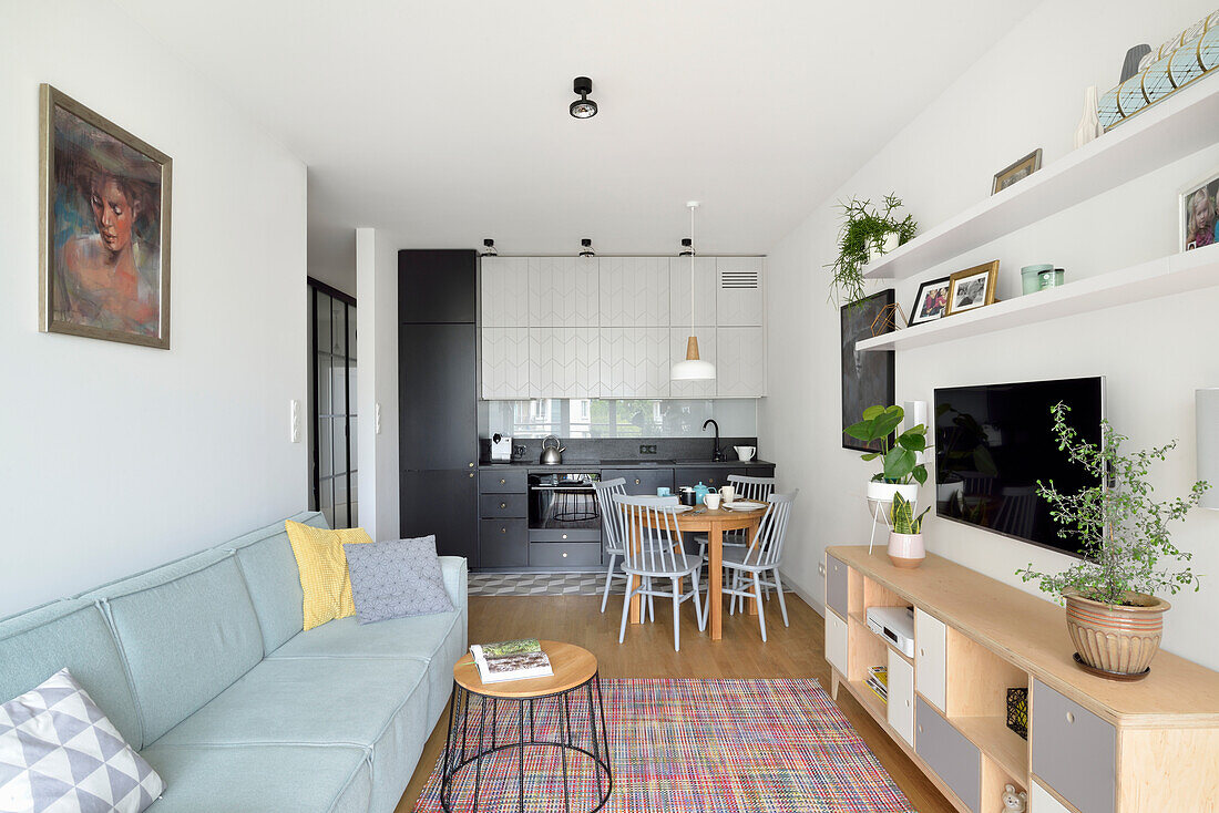 Light-colored living room open to kitchen and dining area