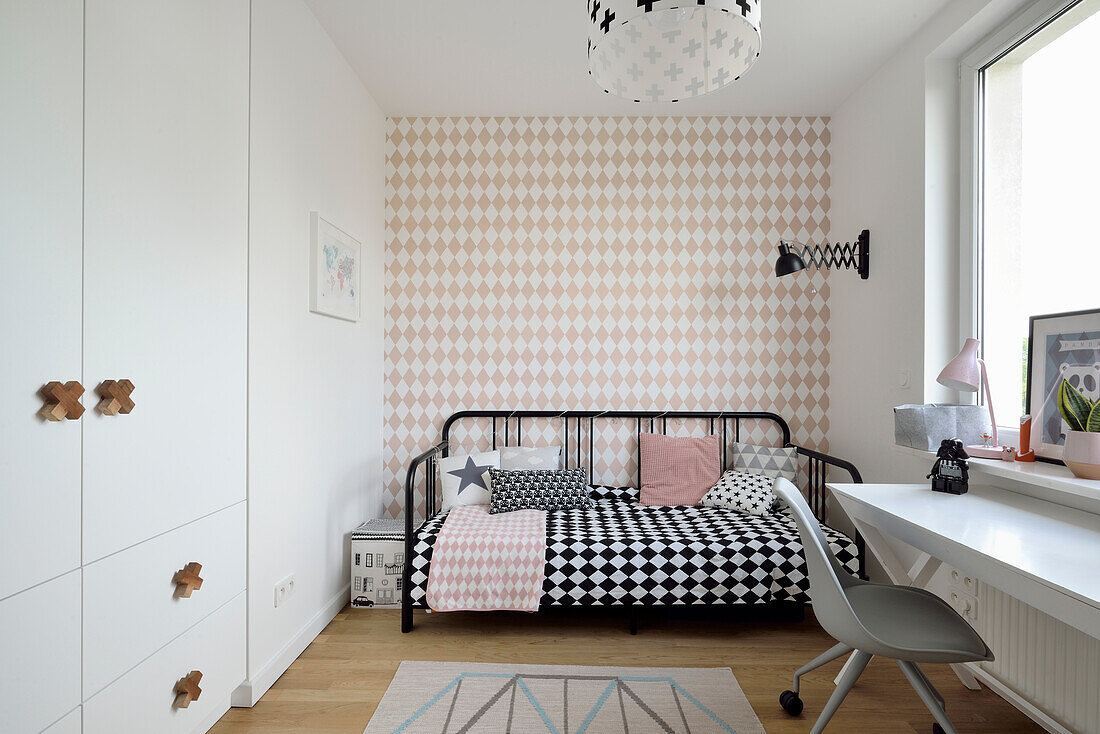 Metal day bed and workstation in the children's room with checkered wallpaper paper