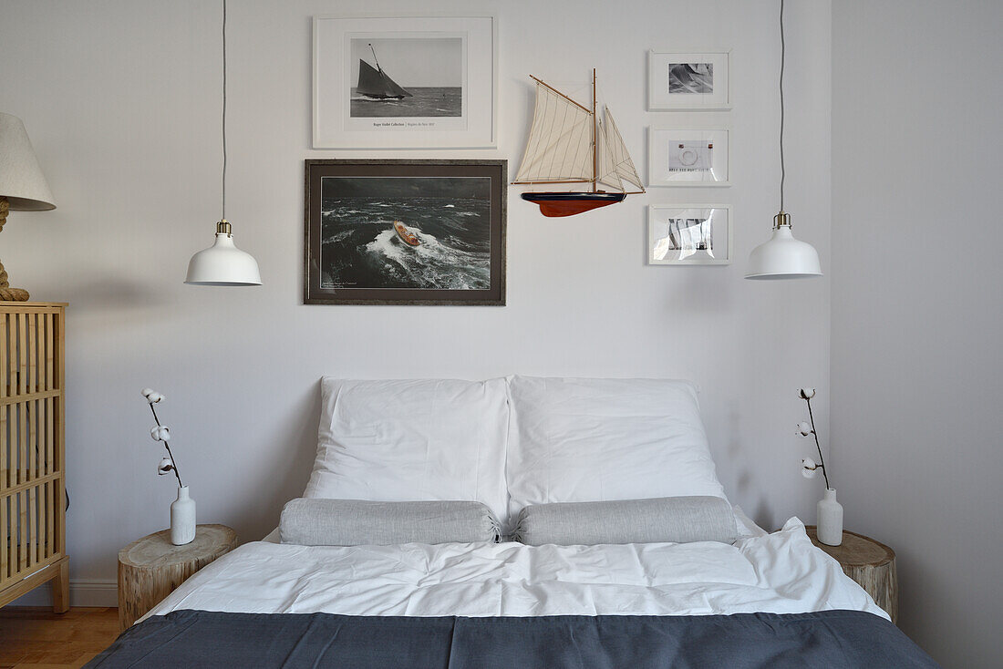 Maritime bedroom with model ship and sailing pictures on the wall