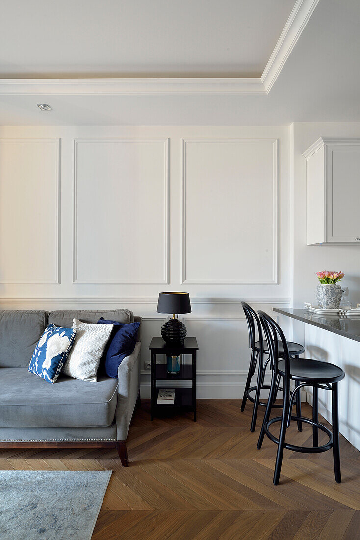 Kitchen with bar stools and adjoining living room