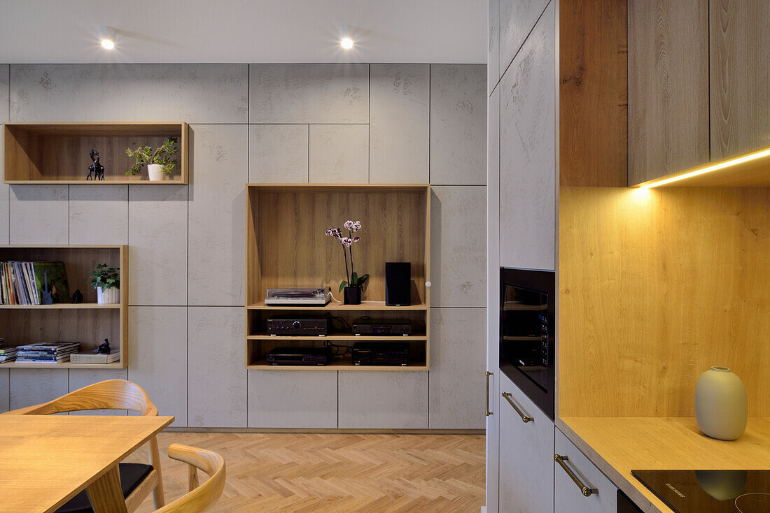 Modern kitchen dining room design with light grey built-in shelving and