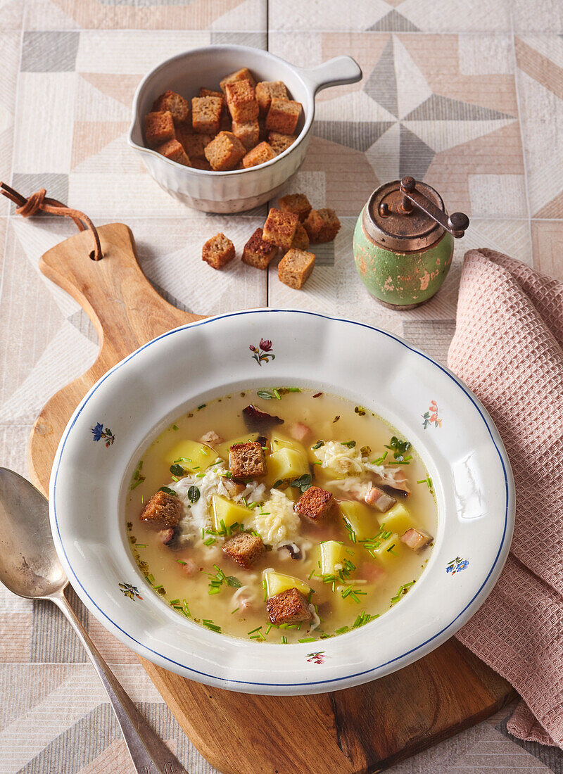 Potato soup with bacon, egg and garlic croutons