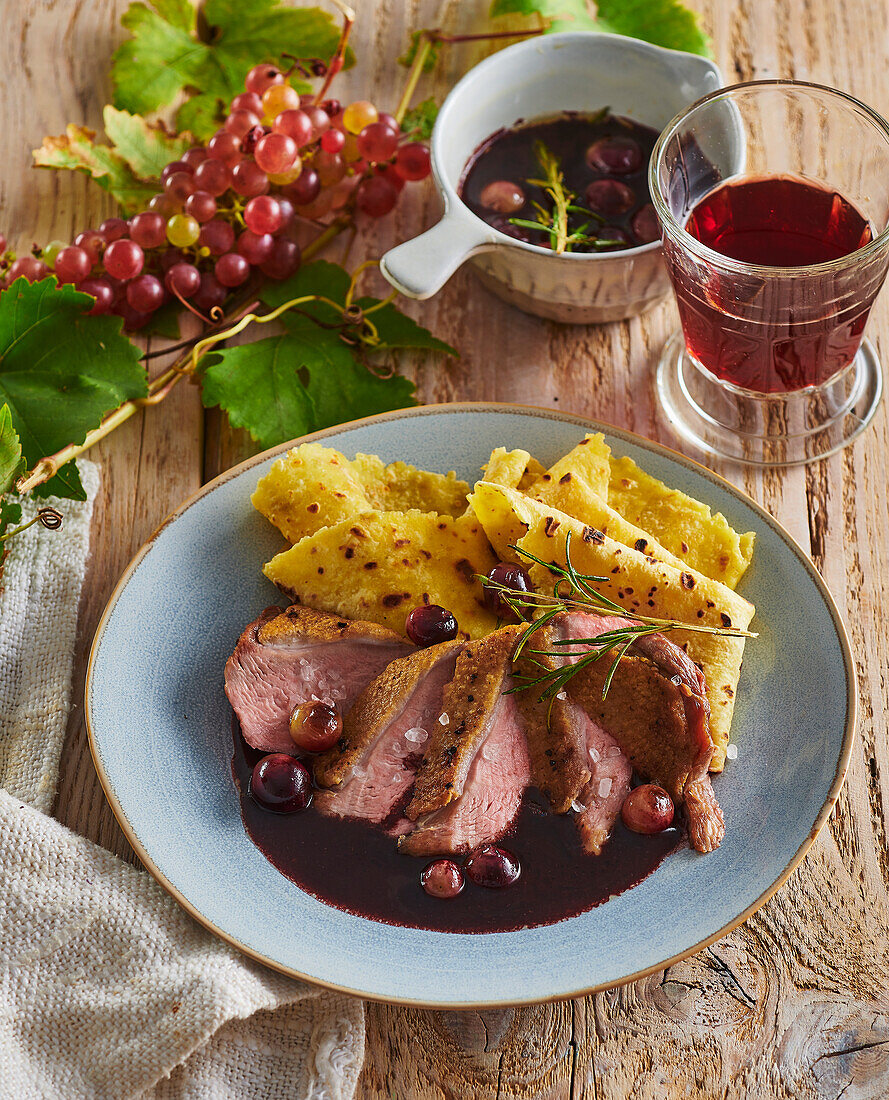 Duck breast with red wine sauce and polenta pancakes
