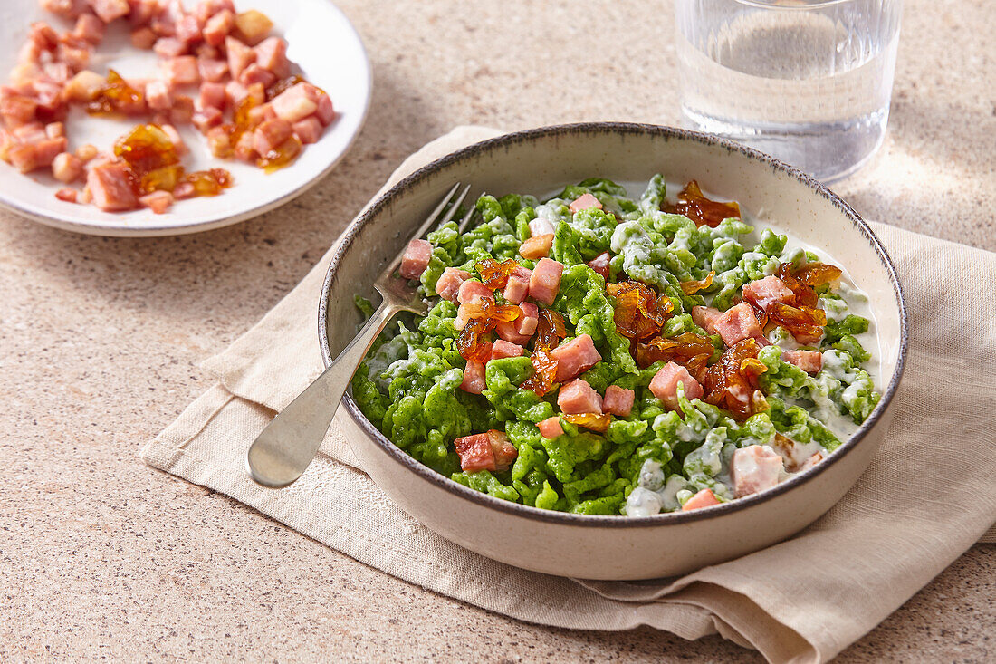 Spinach spaetzle with blue cheese sauce and diced bacon