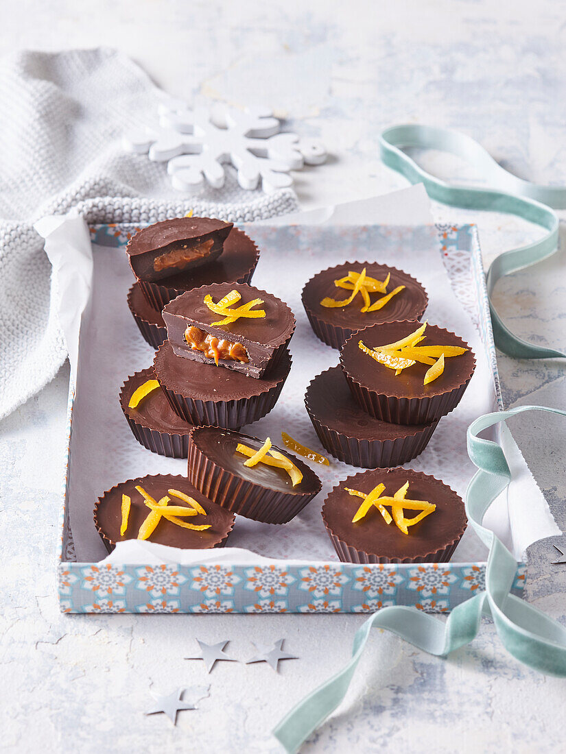 Chocolate tartlets with caramel filling and candied orange peel