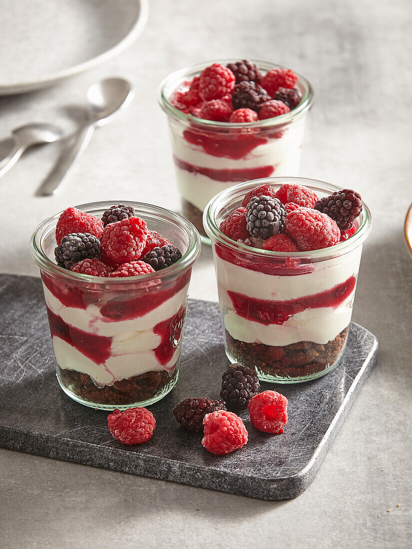 Layered dessert with berries, mascarpone and chocolate biscuits
