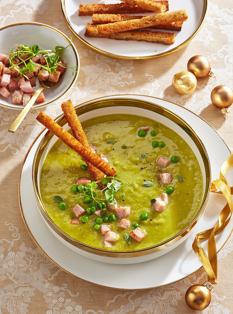 Pea soup with bacon cubes and crispy breadsticks