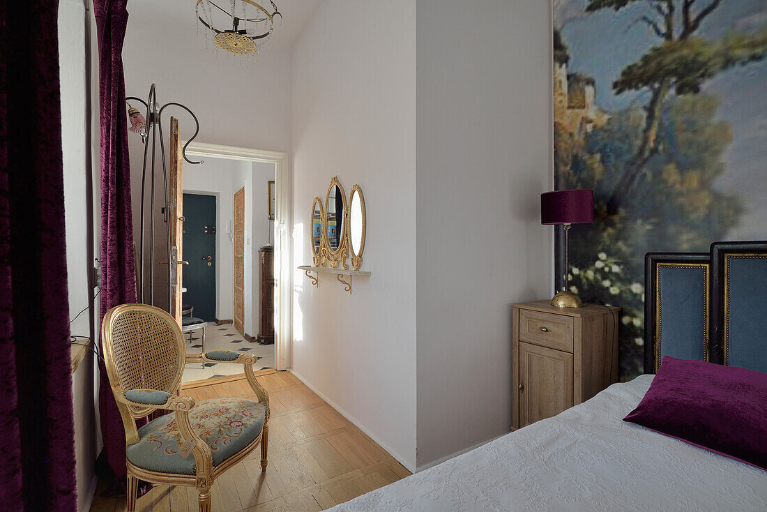 Bedroom with wall painting and baroque rattan chair