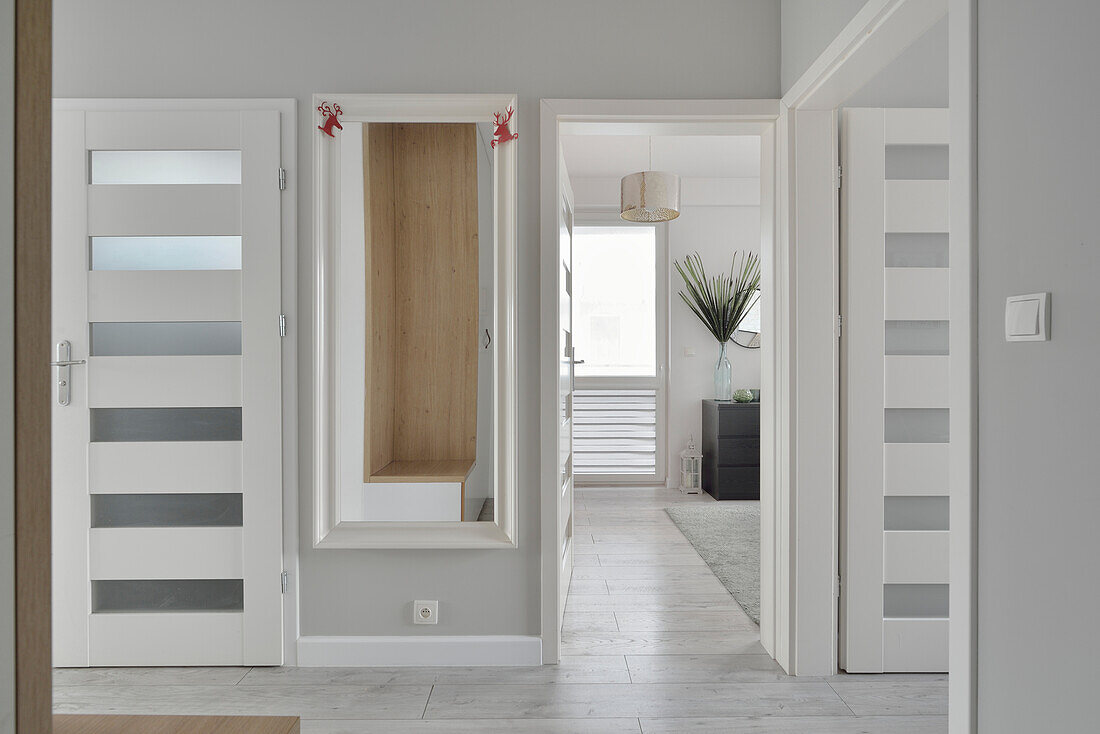 Hallway with wall mirror and white French doors