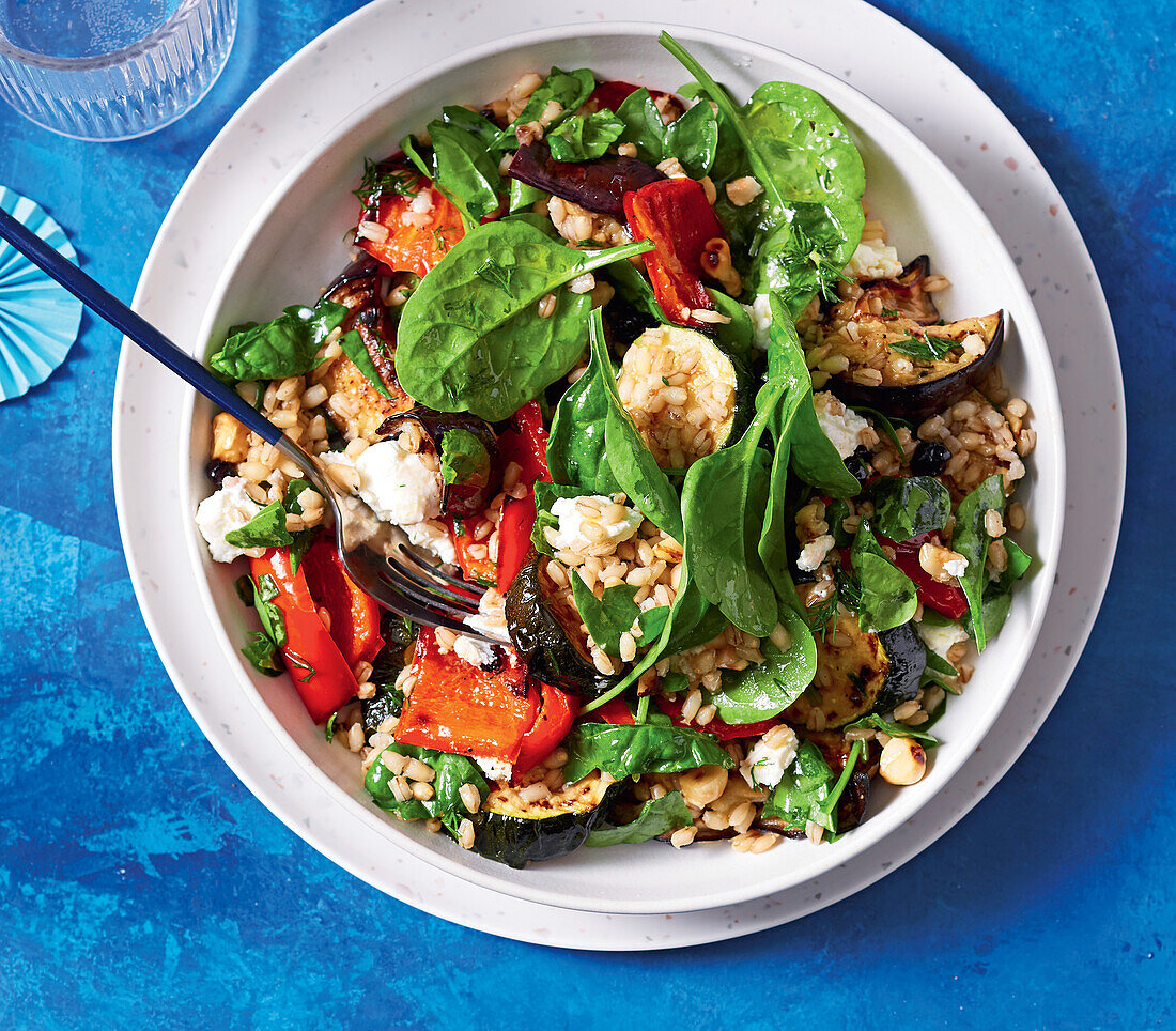 Warm barley salad with courgettes, aubergines, spinach and goat's cheese
