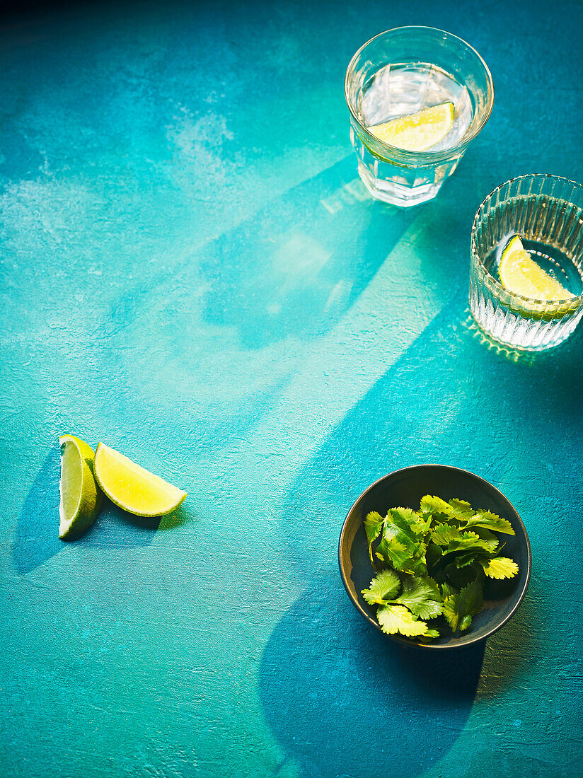 Water with lime wedges and fresh coriander