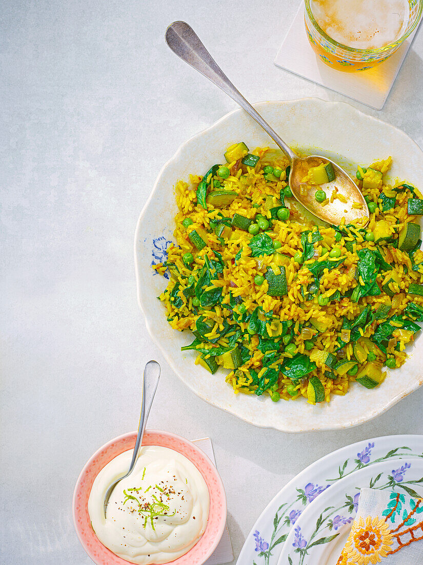 Spring vegetable pilaf with curry and yoghurt dip