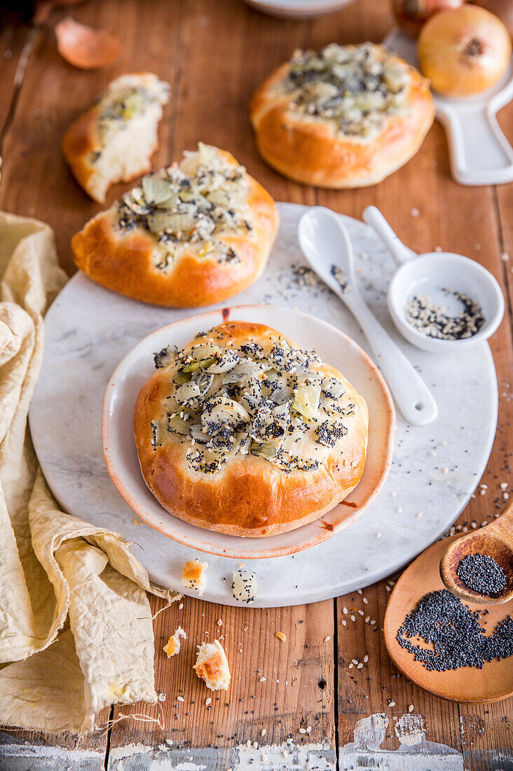 Baked yeast and onion rolls with poppy seeds