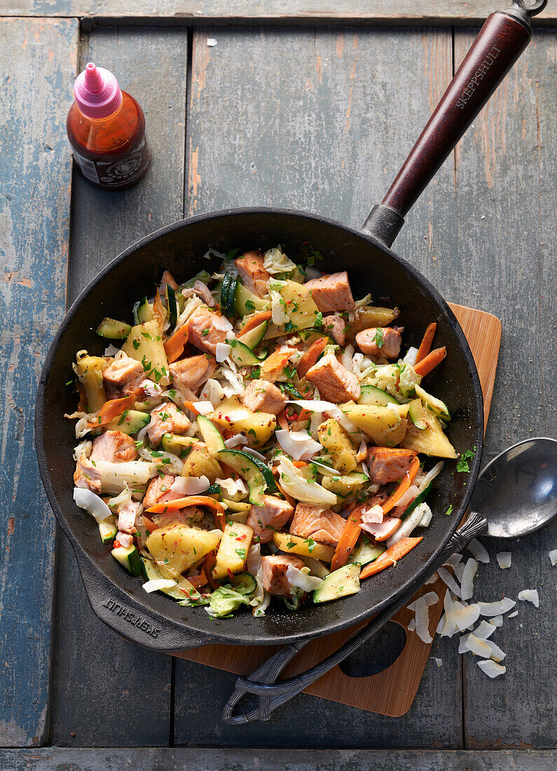 Salmon and pineapple pan with Chinese cabbage, courgette, ginger and coconut chips