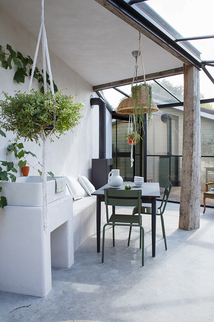 Conservatory with table, chairs, sink and plants