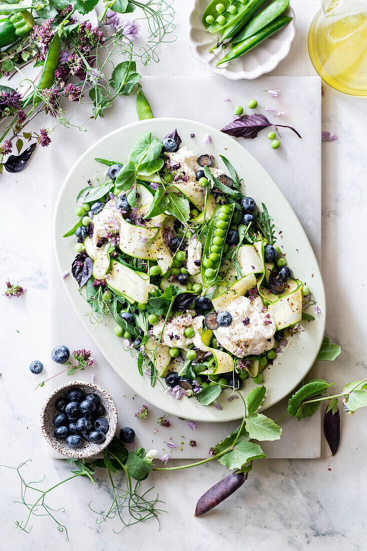 Green pea salad with courgette, blueberries and mozzarella