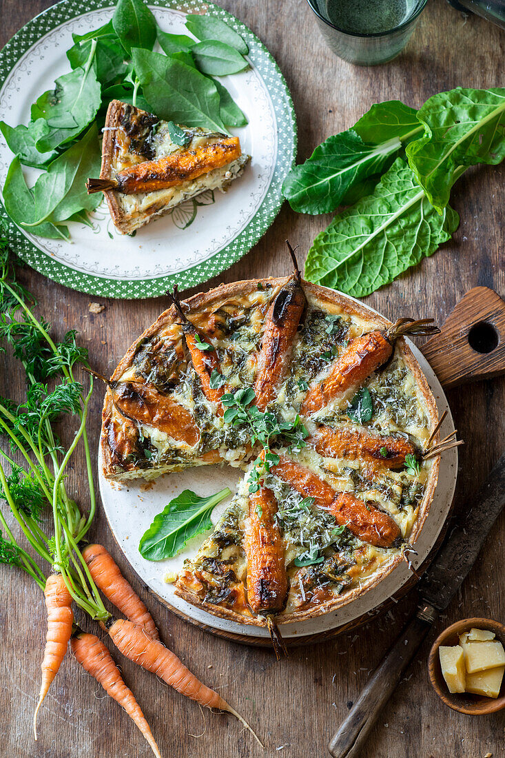 Carrot quiche with fresh herbs and spinach leaves