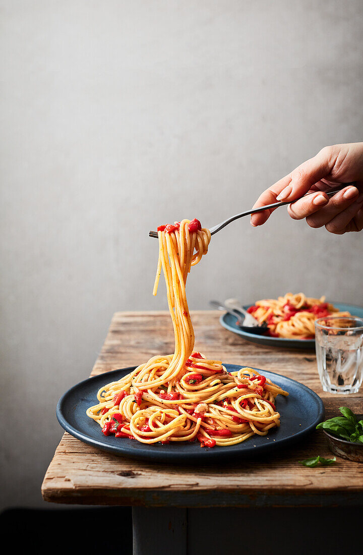 Spaghetti with red pepper strips and anchovies