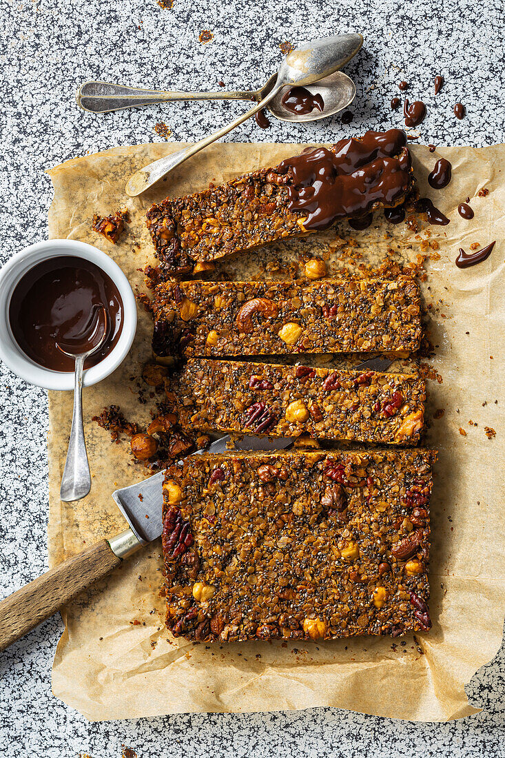 Granola bar with nuts, chia seeds and chocolate icing