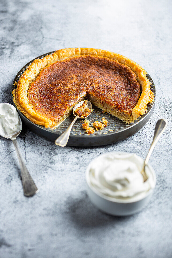Baked almond tart with whipped cream