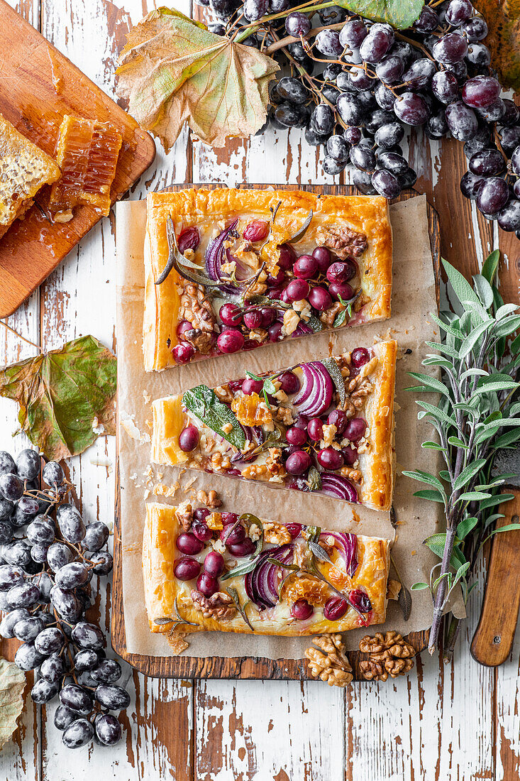Puff pastry tart with grapes, red onions, walnuts and herbs