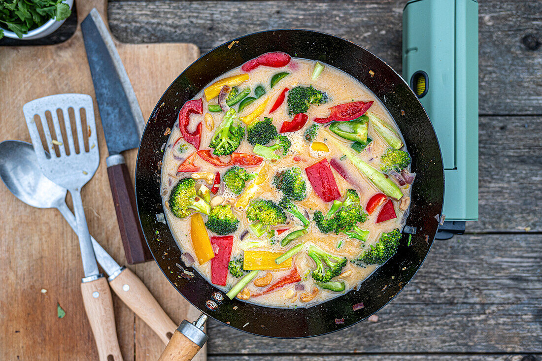 Thai vegetable curry in a wok with broccoli and peppers