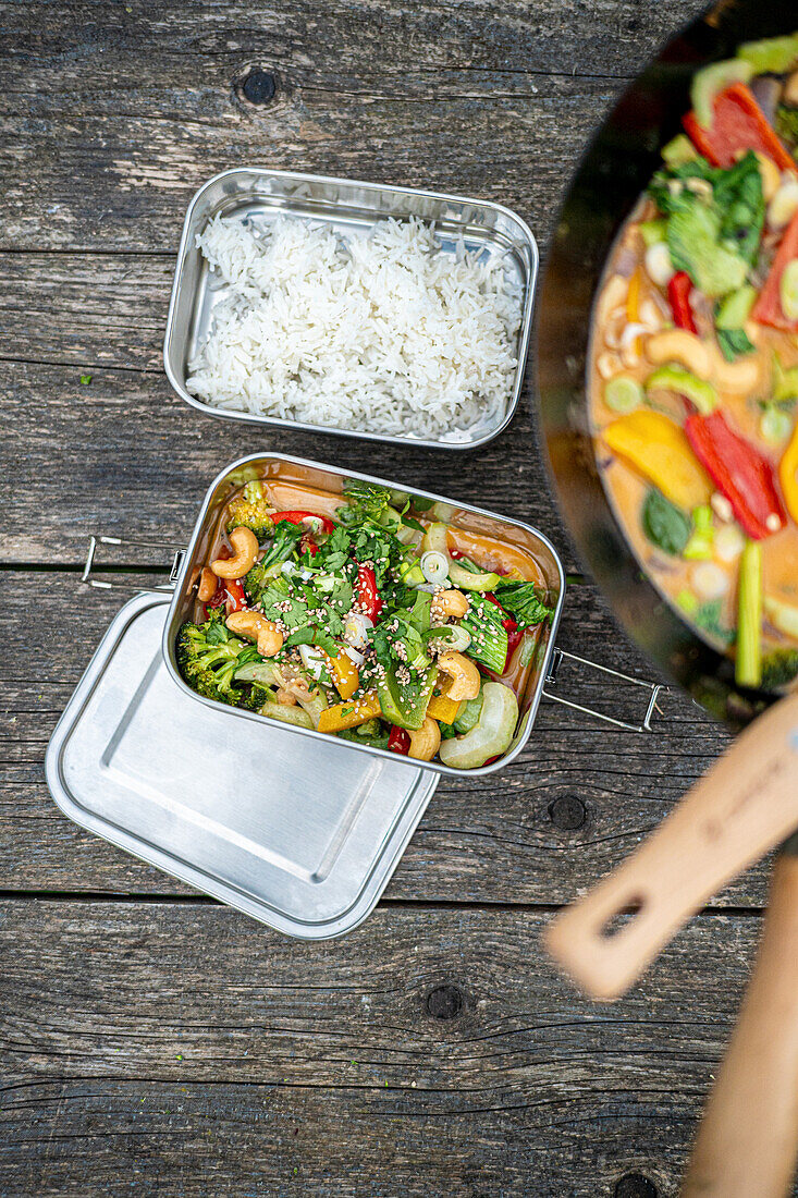 Thai vegetable curry with rice in metal containers