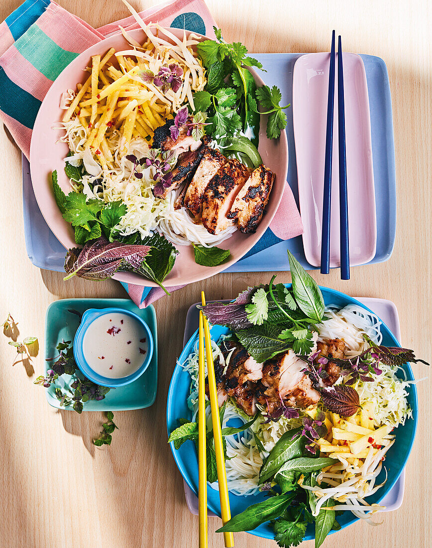 Vietnamese noodle salad bowls with grilled chicken and herbs