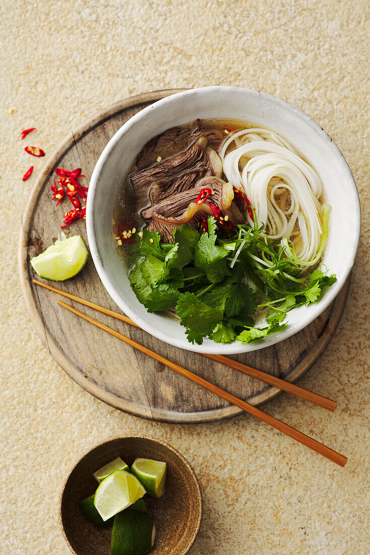Pho bo with boiled beef, rice ribbon noodles and chilli