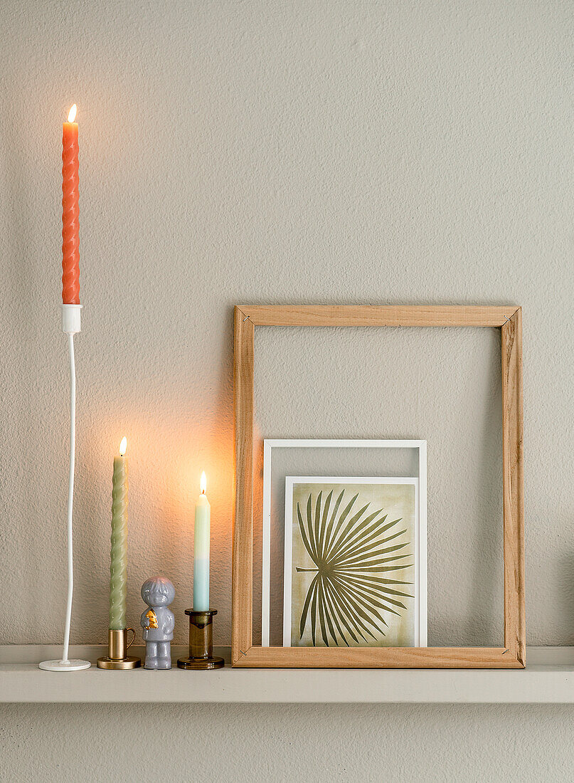 Sideboard with candle holders, picture frame and postcard