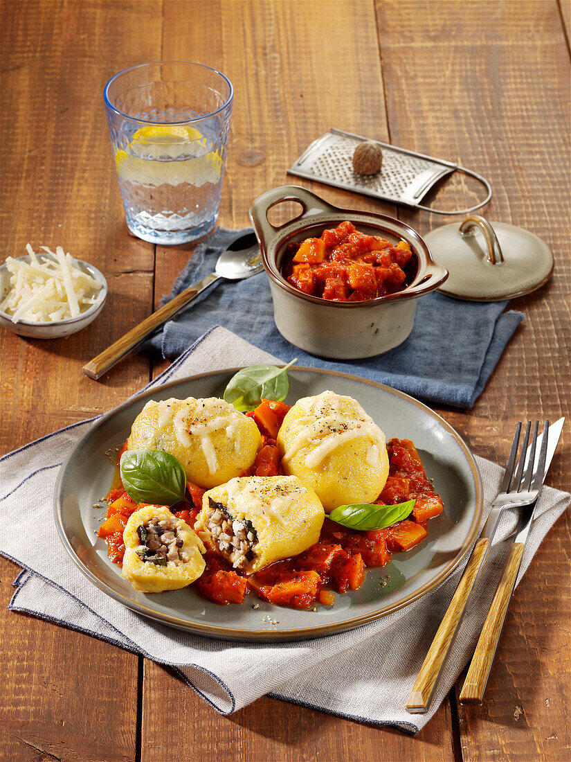 Potato gnocchi with herb and cheese filling and tomato sauce