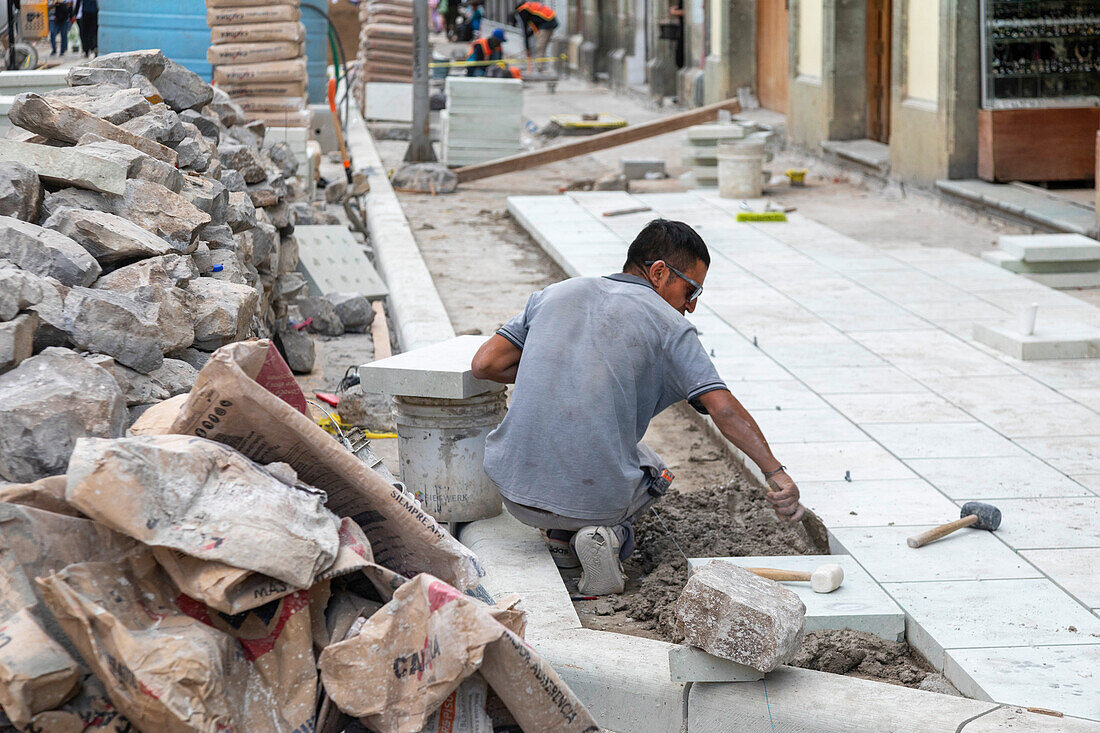 Worker rebuilding street