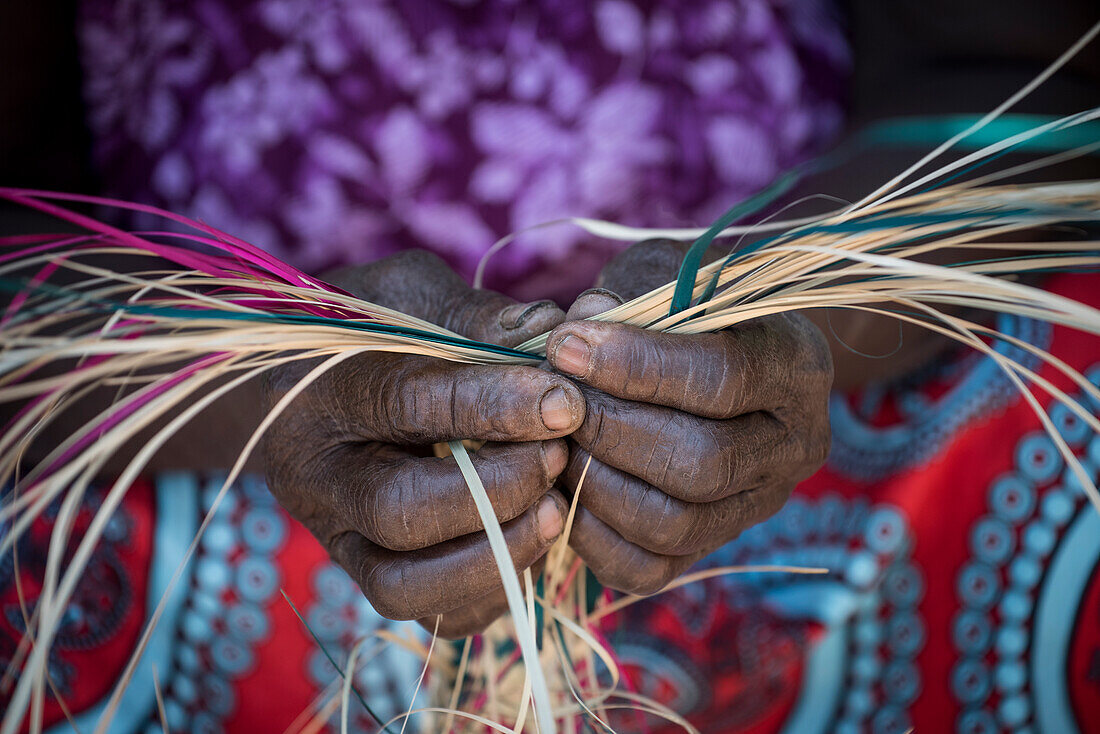 Woman weaving basket, Kenya