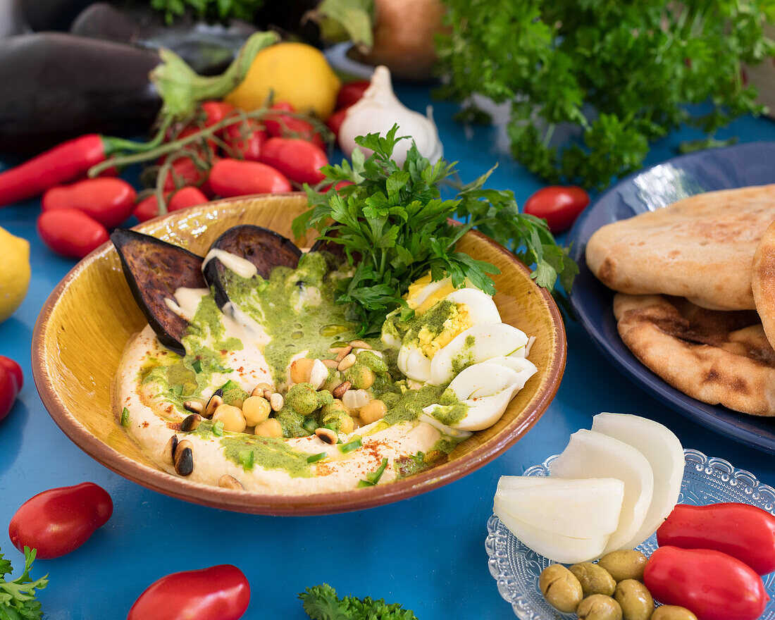 Hummus with fried aubergine, egg and tahini sauce