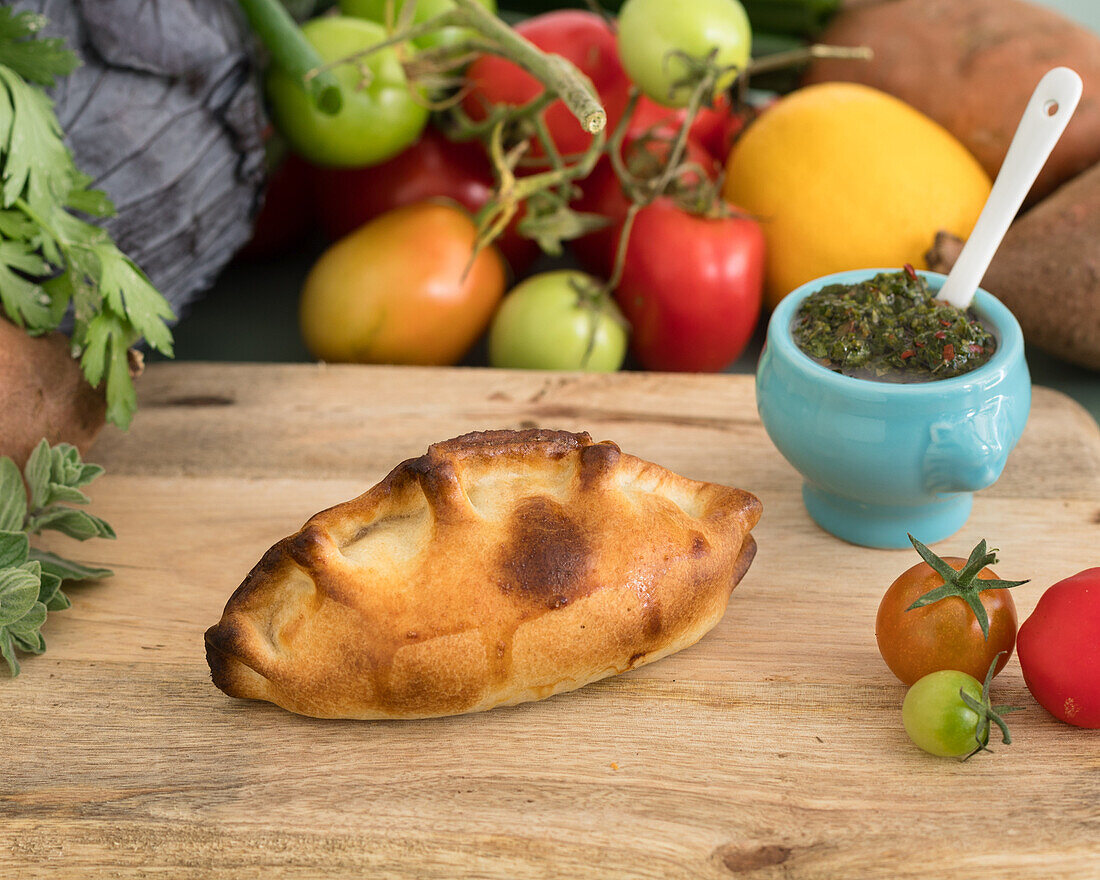 Empanada with chicken filling and chimichurri sauce