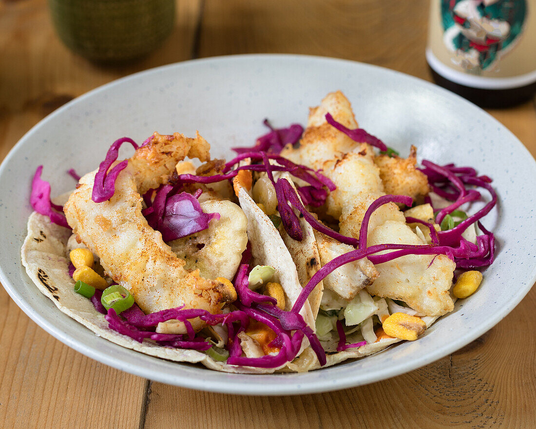 Fish tacos with red cabbage, sweetcorn and spring onions