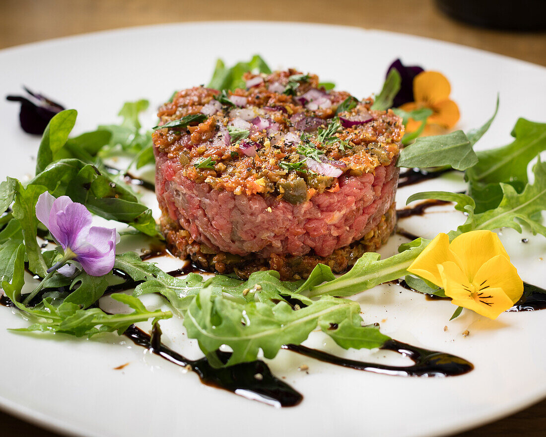 Steak tartare with rocket and edible flowers