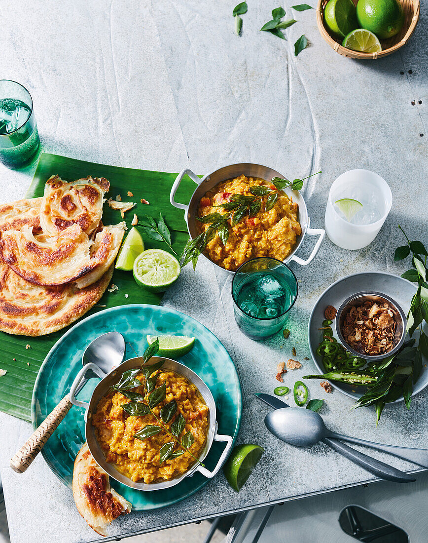 Lentil curry with roti canai and limes
