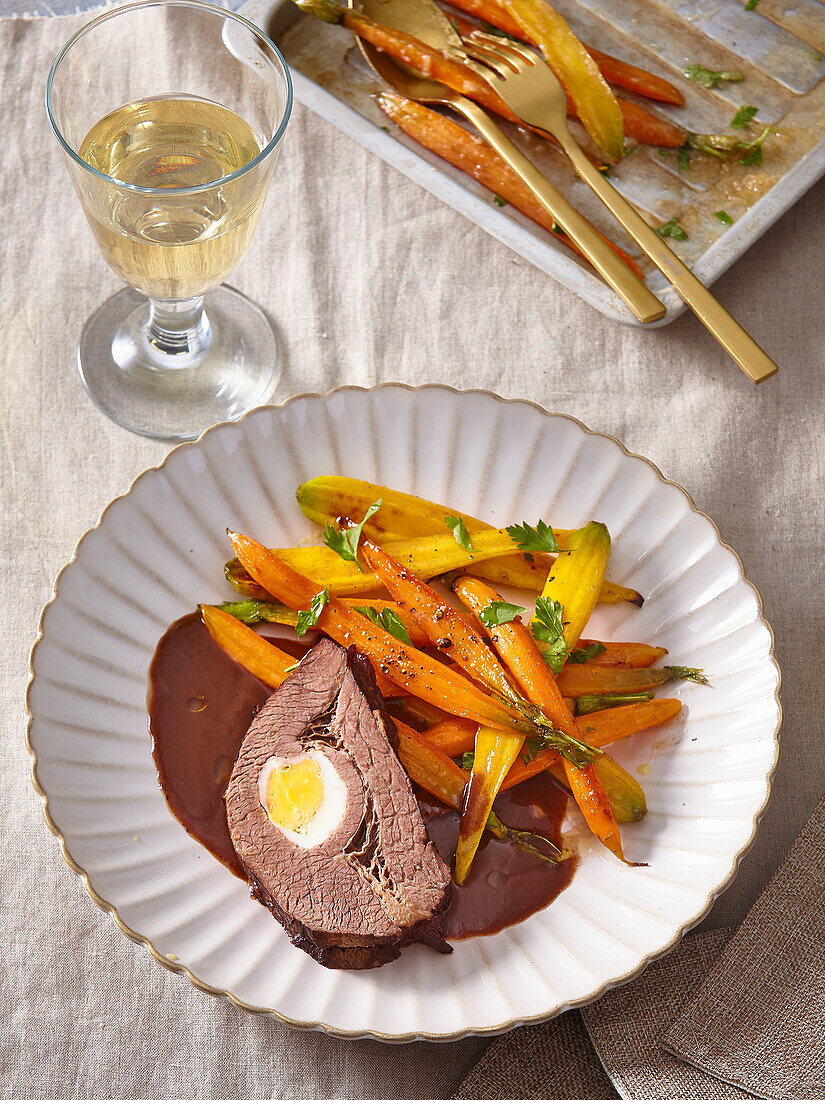 Stuffed roast beef with glazed carrots and red wine sauce
